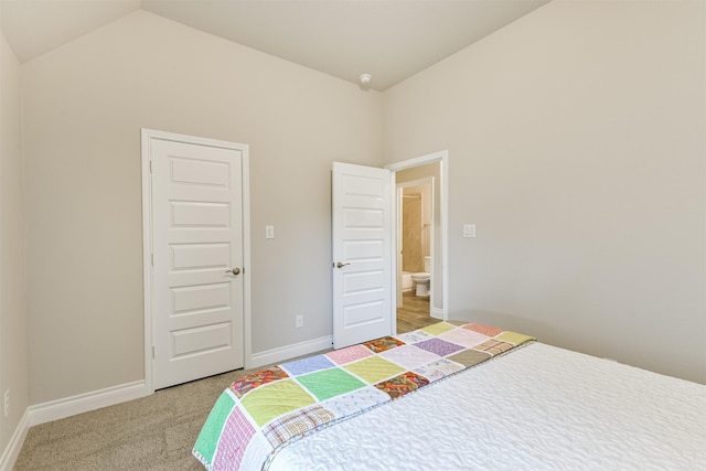 carpeted bedroom with lofted ceiling