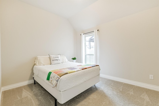 bedroom with carpet flooring and lofted ceiling