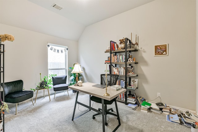 office space featuring light colored carpet and vaulted ceiling