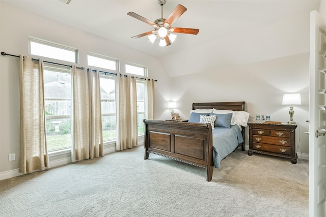 carpeted bedroom featuring ceiling fan and vaulted ceiling