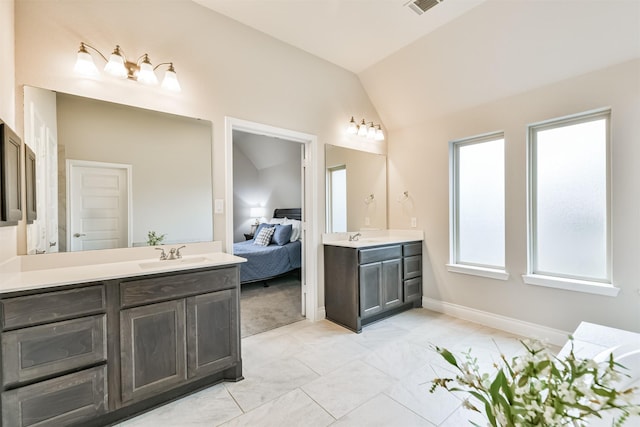 bathroom featuring vanity and lofted ceiling