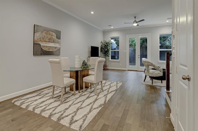 dining space with hardwood / wood-style floors, french doors, crown molding, and ceiling fan