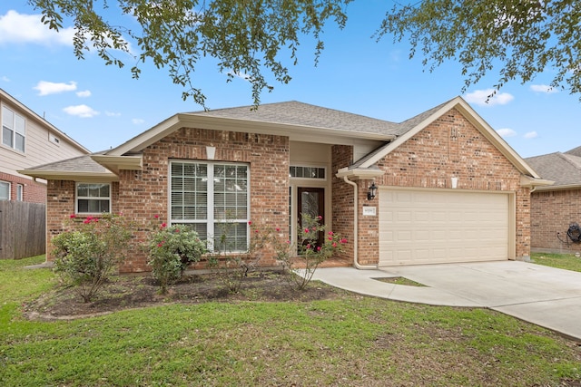 view of front of property featuring a garage and a front yard