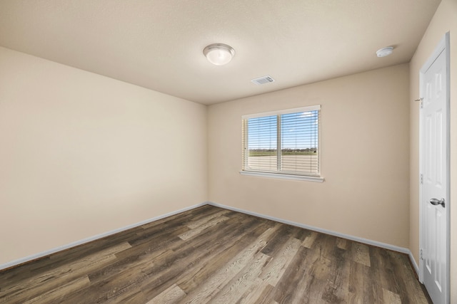 unfurnished bedroom featuring dark wood-type flooring