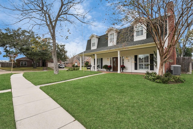 cape cod house featuring a front yard, a porch, and central AC