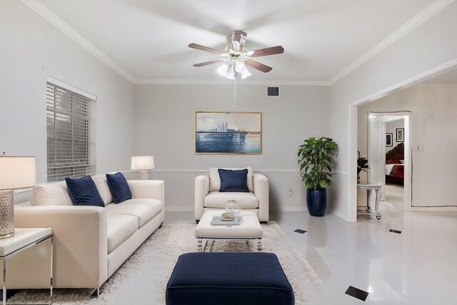 living room featuring ceiling fan, light tile patterned floors, and crown molding