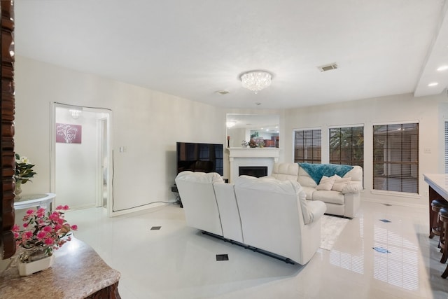 living room featuring light tile patterned floors and a chandelier