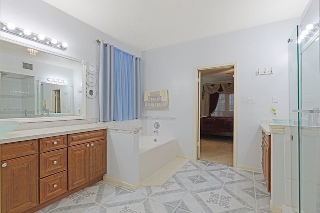 bathroom with vanity and a tub