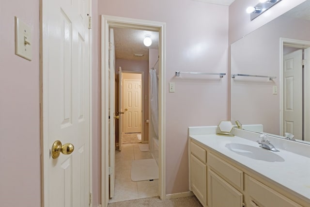 bathroom with vanity, tile patterned floors, and a textured ceiling