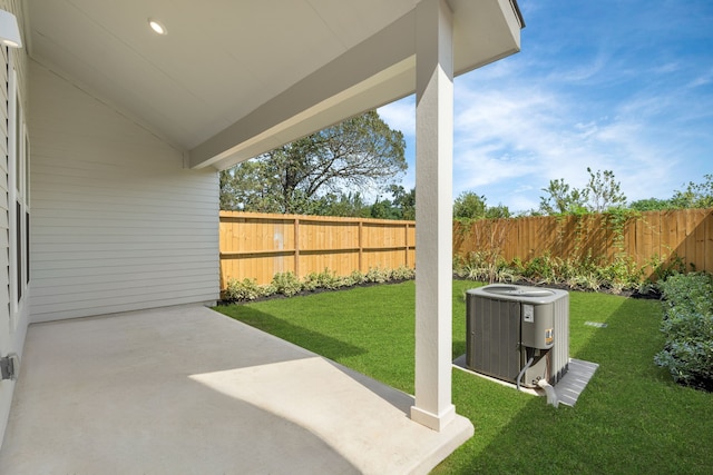 view of yard with central AC unit and a patio area