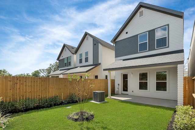 back of house with a yard, cooling unit, and a patio area