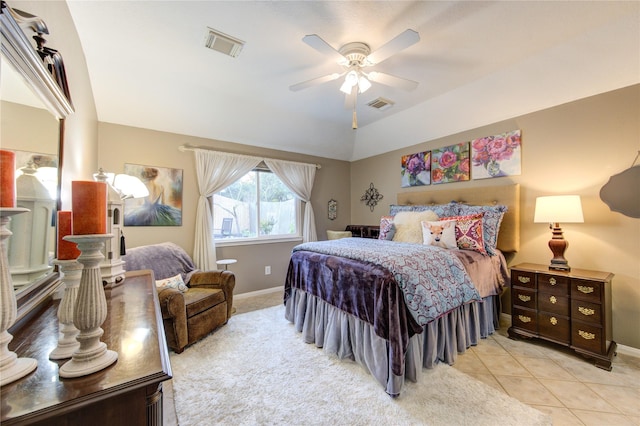 bedroom with ceiling fan, light tile patterned floors, and lofted ceiling