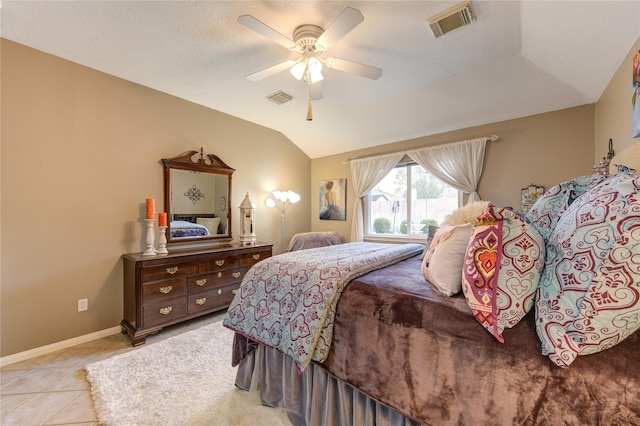 bedroom featuring vaulted ceiling, ceiling fan, and light tile patterned flooring