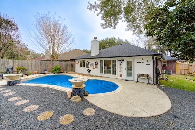 view of pool featuring central air condition unit and a patio area