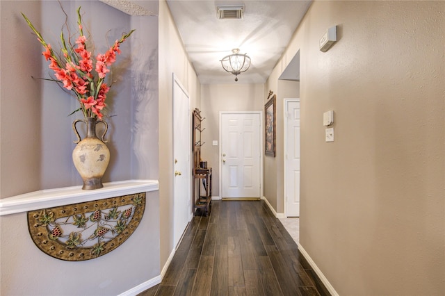 corridor with dark hardwood / wood-style floors