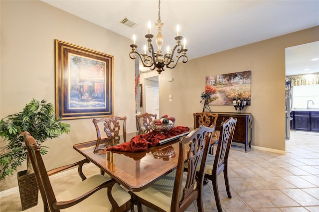 tiled dining space featuring sink and a notable chandelier