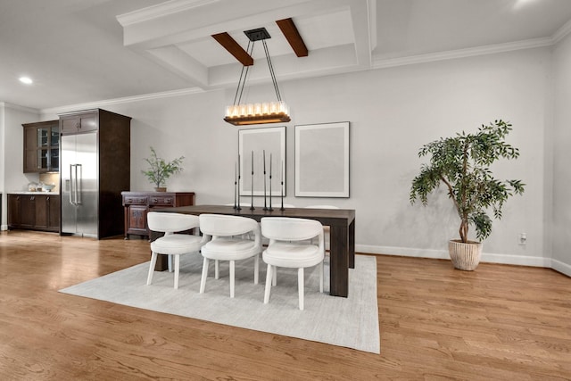 dining area with beam ceiling, crown molding, light hardwood / wood-style flooring, and coffered ceiling