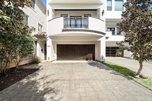 view of front facade with a garage and a balcony