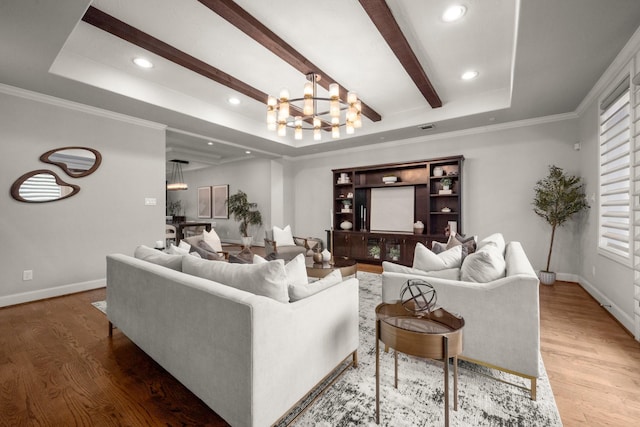 living room featuring hardwood / wood-style flooring, a notable chandelier, and a raised ceiling