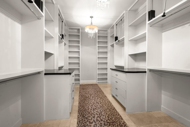 walk in closet featuring a chandelier