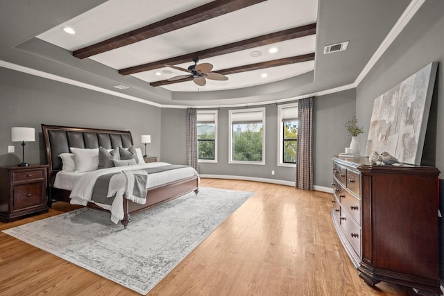 bedroom with a tray ceiling, ceiling fan, and light hardwood / wood-style floors