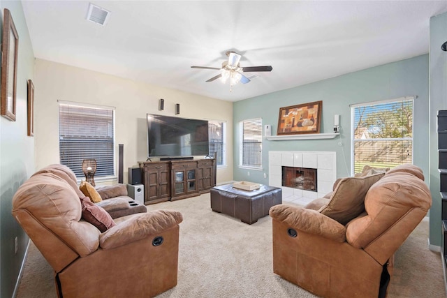 living room with light carpet, a fireplace, and ceiling fan