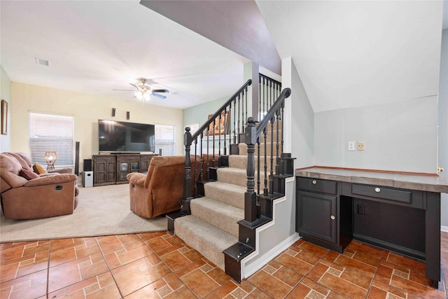 stairway featuring carpet, ceiling fan, and plenty of natural light