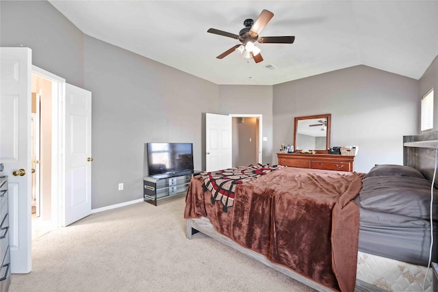 bedroom with ceiling fan, light colored carpet, and vaulted ceiling