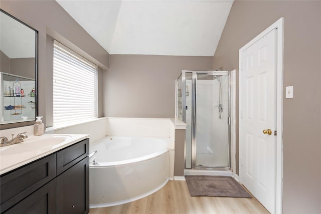 bathroom featuring separate shower and tub, hardwood / wood-style floors, vanity, and lofted ceiling