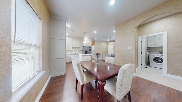 dining space with washer / dryer and hardwood / wood-style flooring