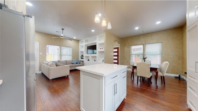 kitchen featuring white cabinets, built in shelves, ceiling fan, and dark hardwood / wood-style floors