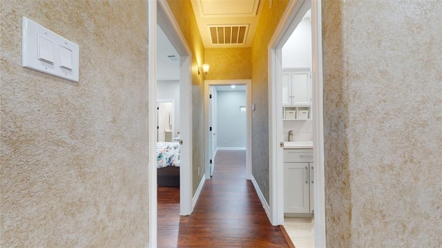 corridor with sink and dark hardwood / wood-style floors