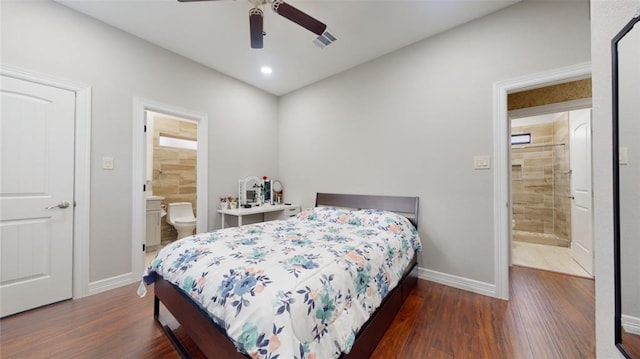 bedroom featuring ensuite bath, ceiling fan, and dark wood-type flooring