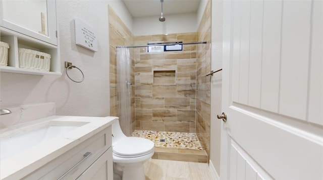 bathroom with vanity, a shower with shower curtain, and toilet