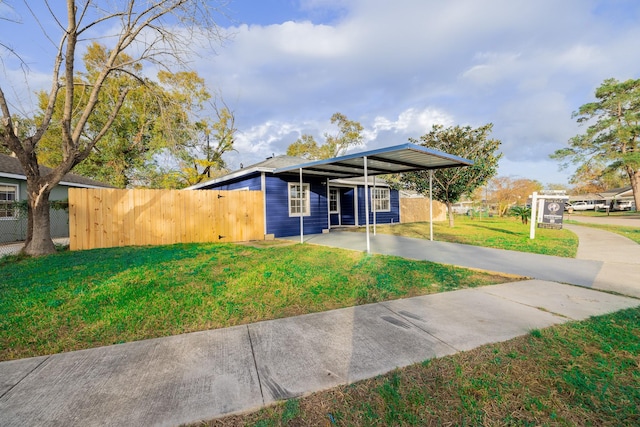 view of front of house with a front yard and a carport