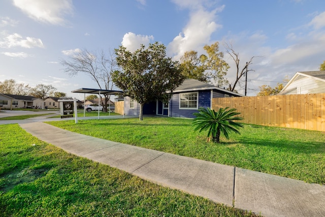 view of front of house with a carport and a front lawn