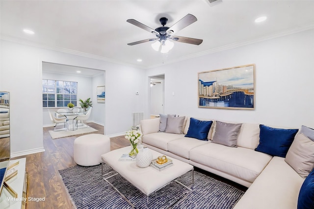 living room with ceiling fan, ornamental molding, and wood-type flooring