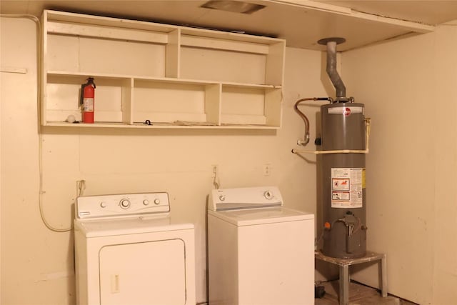 washroom with washing machine and dryer and water heater