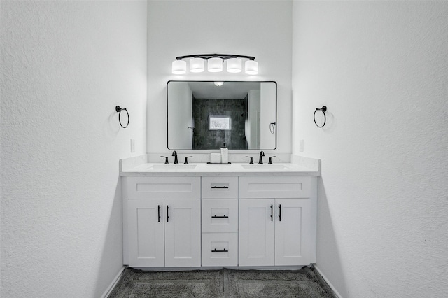 bathroom with vanity and a tile shower