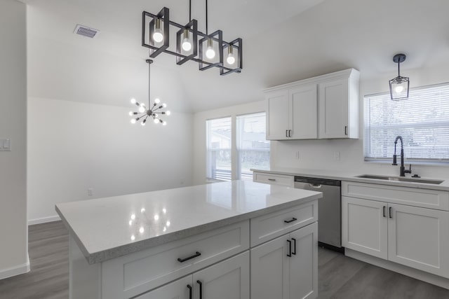 kitchen with white cabinets, pendant lighting, stainless steel dishwasher, and sink