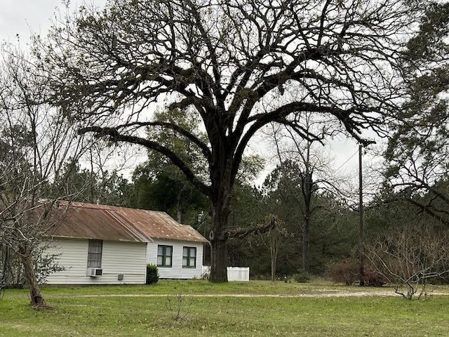 view of property exterior with a lawn