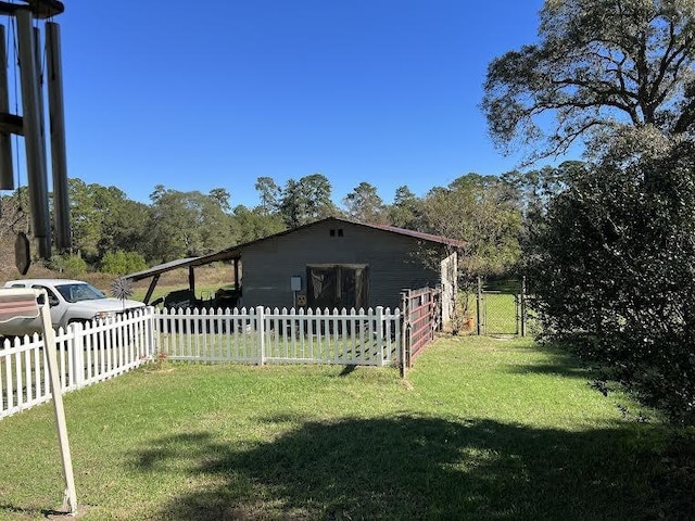 view of side of home with a yard