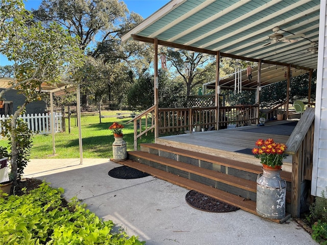 deck featuring a yard and ceiling fan