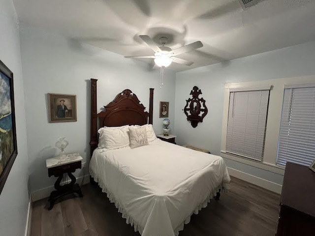 bedroom featuring ceiling fan and dark wood-type flooring