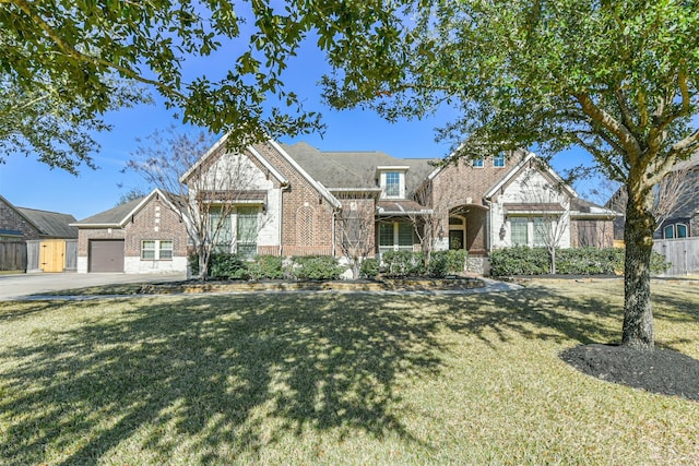 view of front of property featuring a garage and a front lawn