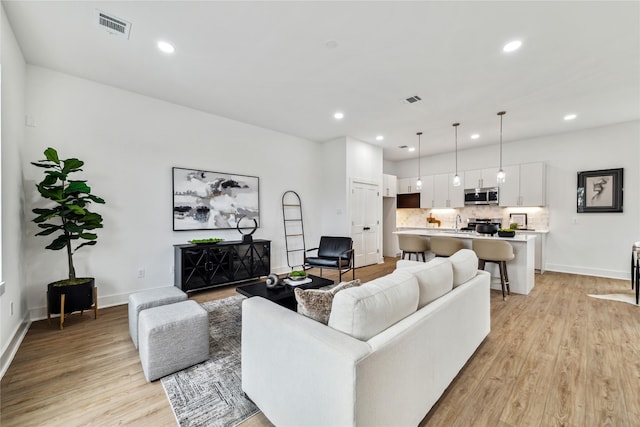 living room with light hardwood / wood-style floors