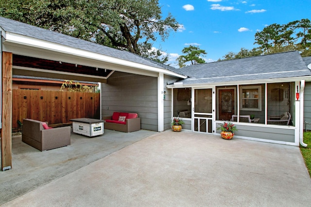 view of patio featuring outdoor lounge area and a sunroom