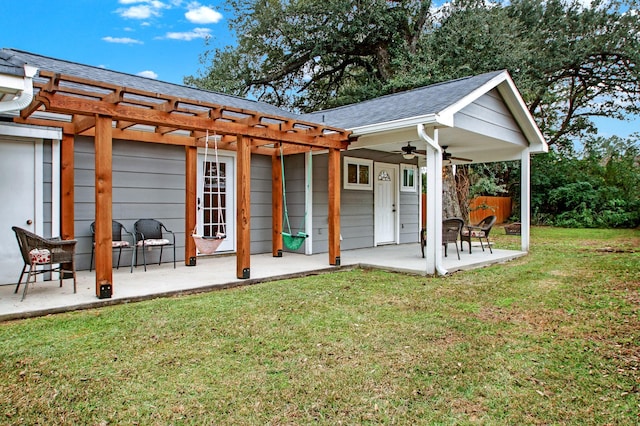 back of house featuring ceiling fan, a patio area, a pergola, and a yard