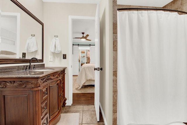 bathroom featuring tile patterned flooring, vanity, and ceiling fan