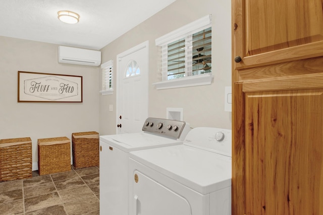 washroom featuring a wall mounted air conditioner and washer and dryer